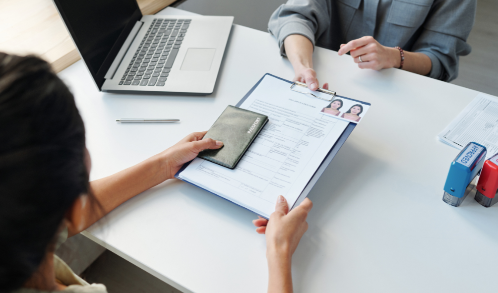 Image of handing over documents needed for Denmark Student Visa.