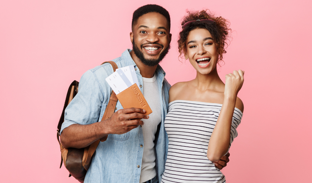 Image of a happy man and a woman and the man holding a passport.