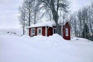 Snowy red cottage Sweden