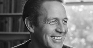 C F Moller smiling.