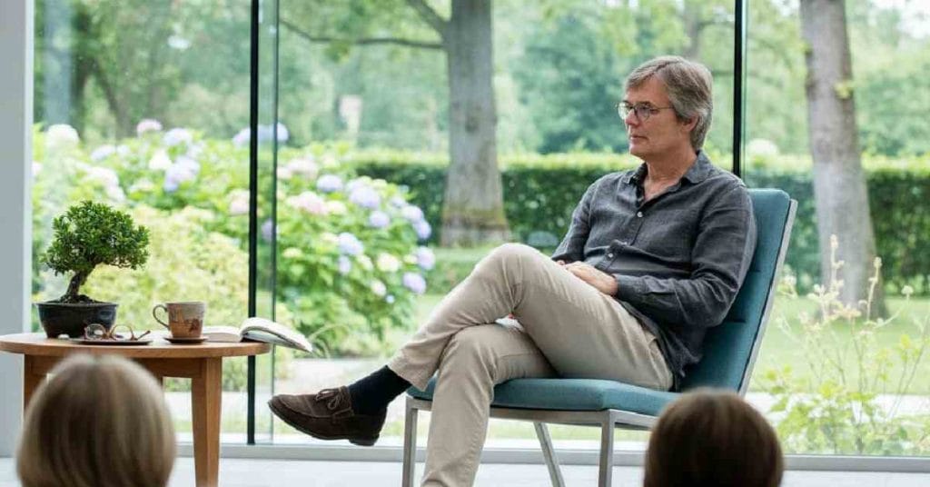 Bille August sitting.