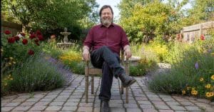 Lars Von Trier sitting.