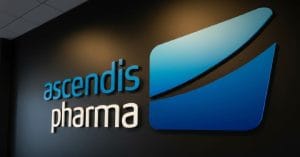 Ascendis Pharma A/S logo on a black wall.